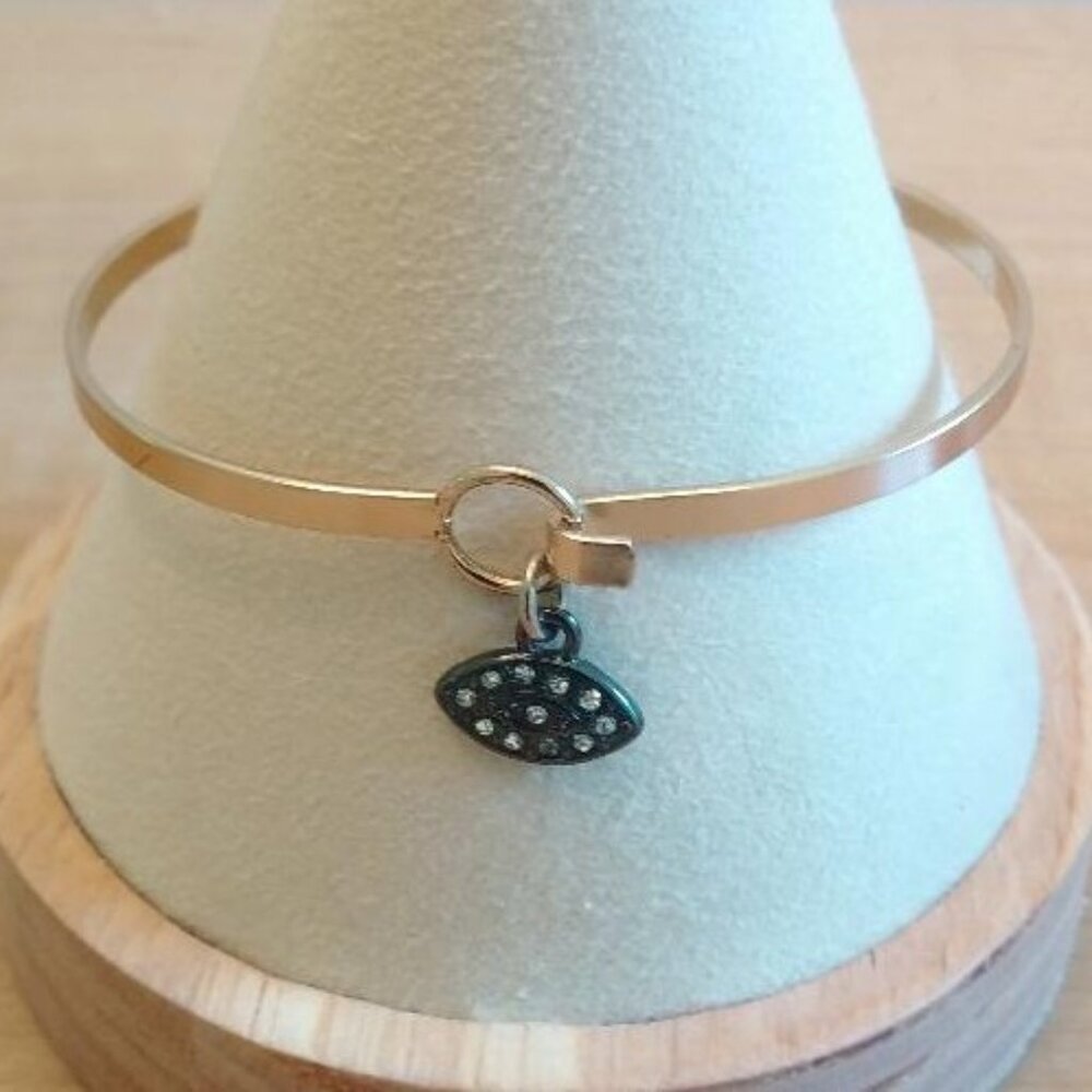 Gold Tone Bangle Bracelet with Gun Metal Tone Eye with Rhinestones Charm